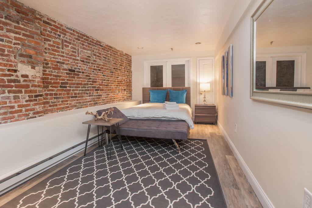 Large master bedroom with reclined sofa