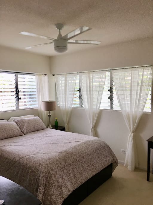 Airy bedroom surrounding by trees