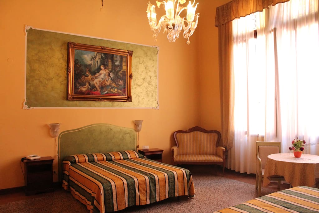 QUADRUPLE room OVERLOOKING small canal with private bathroom OUTSIDE the room (only one meter outside the room).