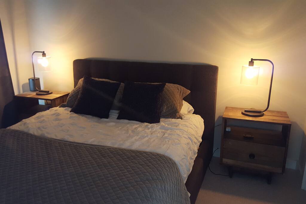 All lighting can be controlled remotely with an app - or provided iPad - or manually. Motion censor turns lights off when you leave the apartment and back on when you arrive. Function can be disabled if desired. Bedding: sheep's wool duvet, Egyptian cotton sheets, velvet secondary sheet and pillow covers, Tempur-pedic mattress, reclaimed wood nightstands.