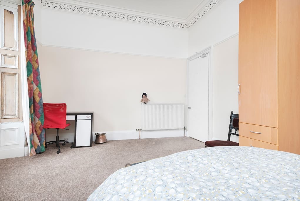 This is the large double showing the desk which is also in the room.