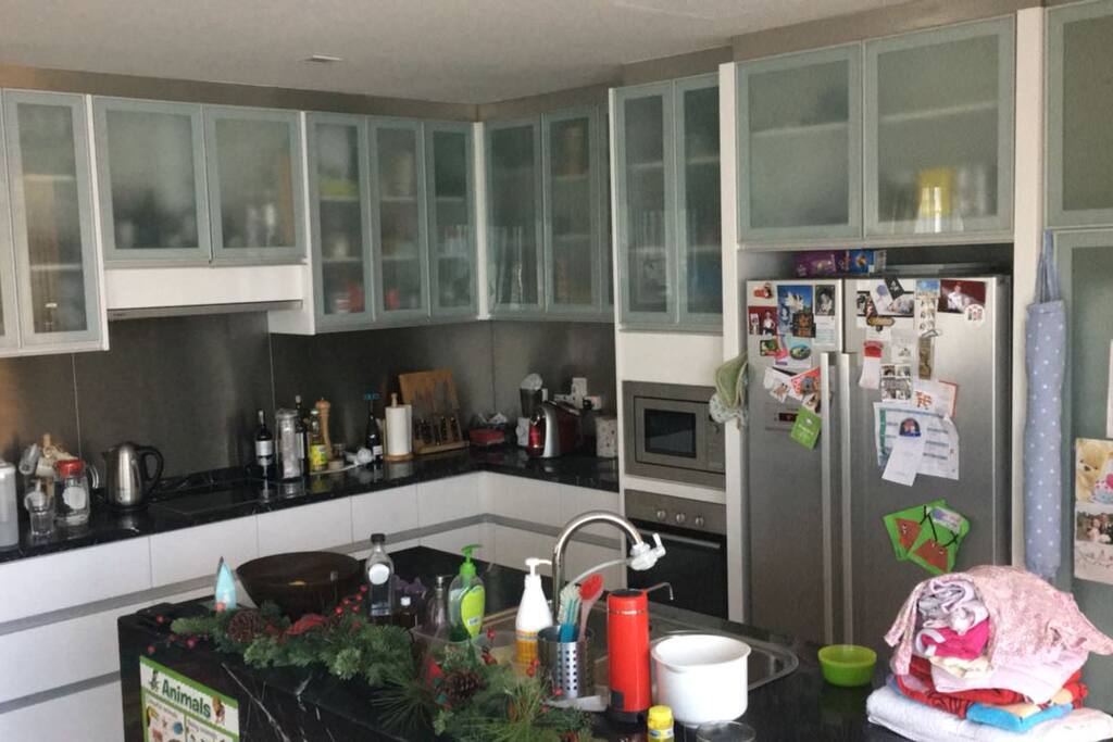 Open plan kitchen - fully equipped with toaster, microwave, coffee machine, oven stovetop, cooking utensils, cutlery, glassware, etc