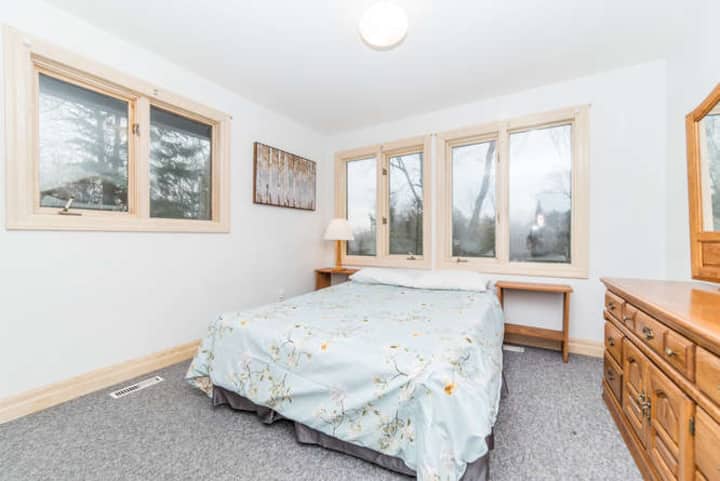 Across from the master is the second bedroom equipped with a queen size bed and numerous windows to bring in lots of light.