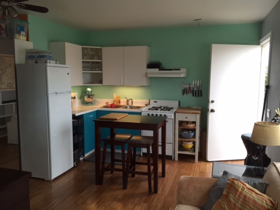 View of kitchen and front door from the living room