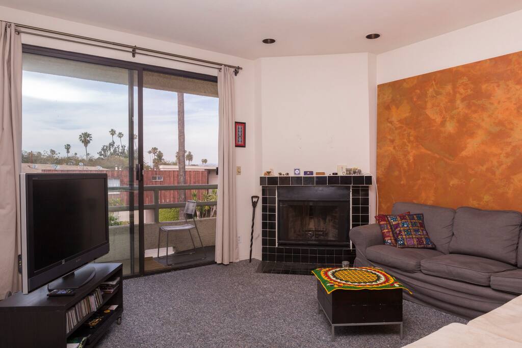Living Room w/ Fireplace & Patio