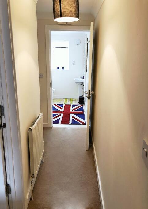 The corridor with mean access to the bathroom and bedroom and the living room and kitchen
