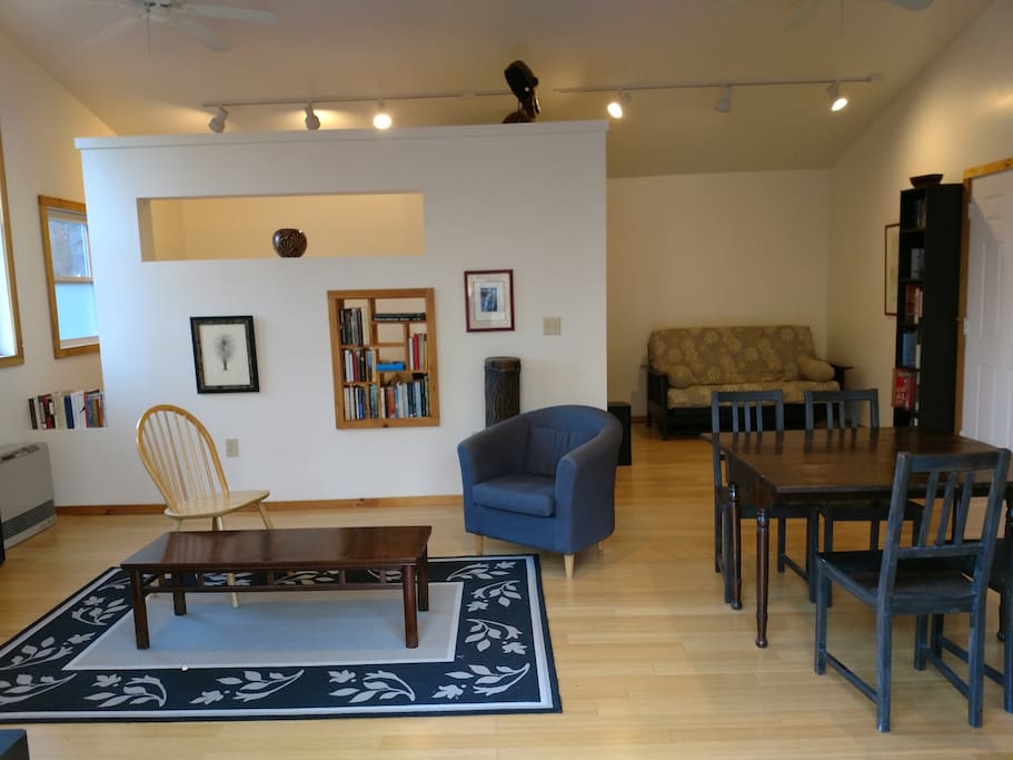 Bright, spacious living area with vaulted ceilings and overhead fans.