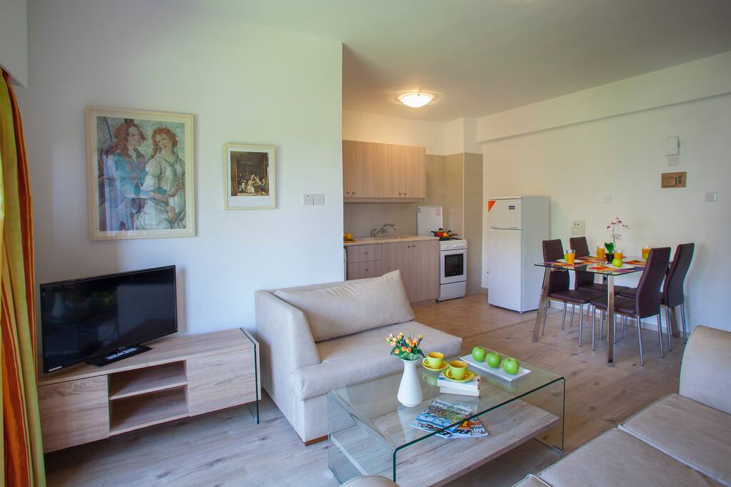 TV area, dining table and kitchen