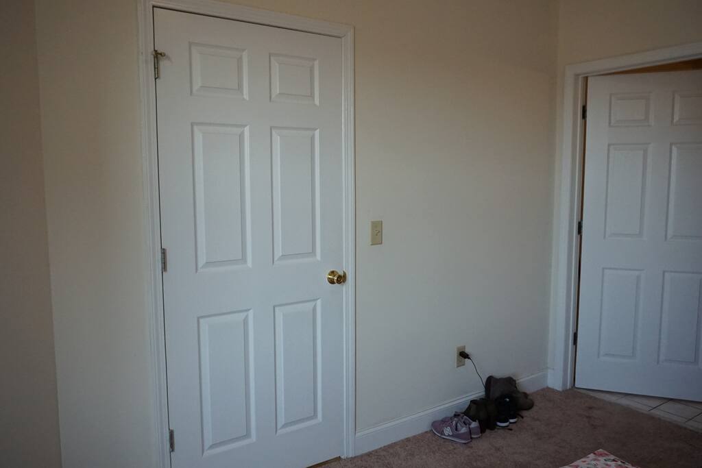 Two doors, one leading to the living room and the other one, bathroom