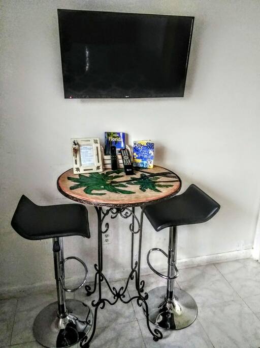Work table, chairs, TV, Fire TV stick, Amazon Prime, Netflix, streaming apps.