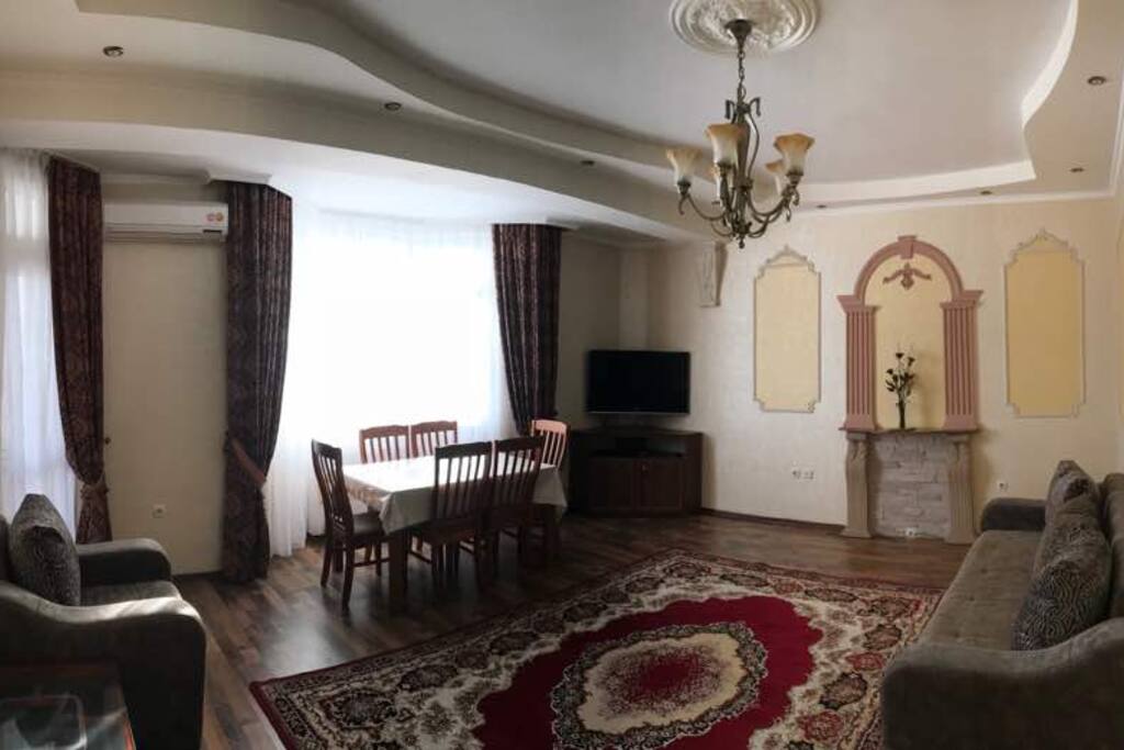 Living room: TV, dining table, carpet, sofa (reversible as a comfortable bed for two), two sofa, coffee table.