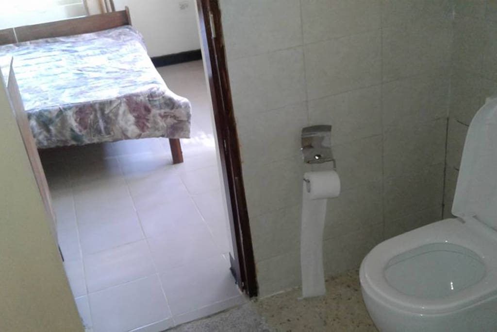 The toilet leading to the master bedroom, with toilet paper
