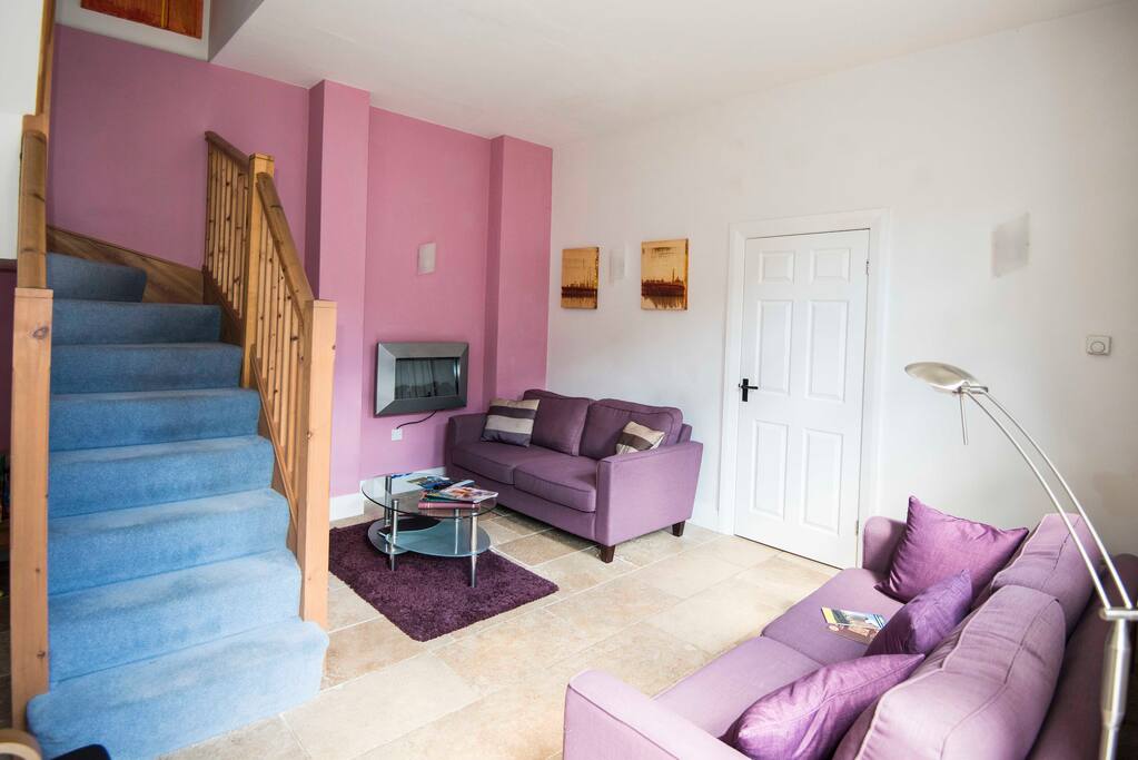 Stairs from lounge up to two airy beamed bedrooms.