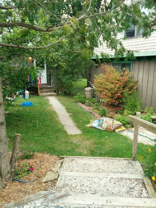 Stairs and walkway to the house. Duck under the pines and pass the apple tree on route!