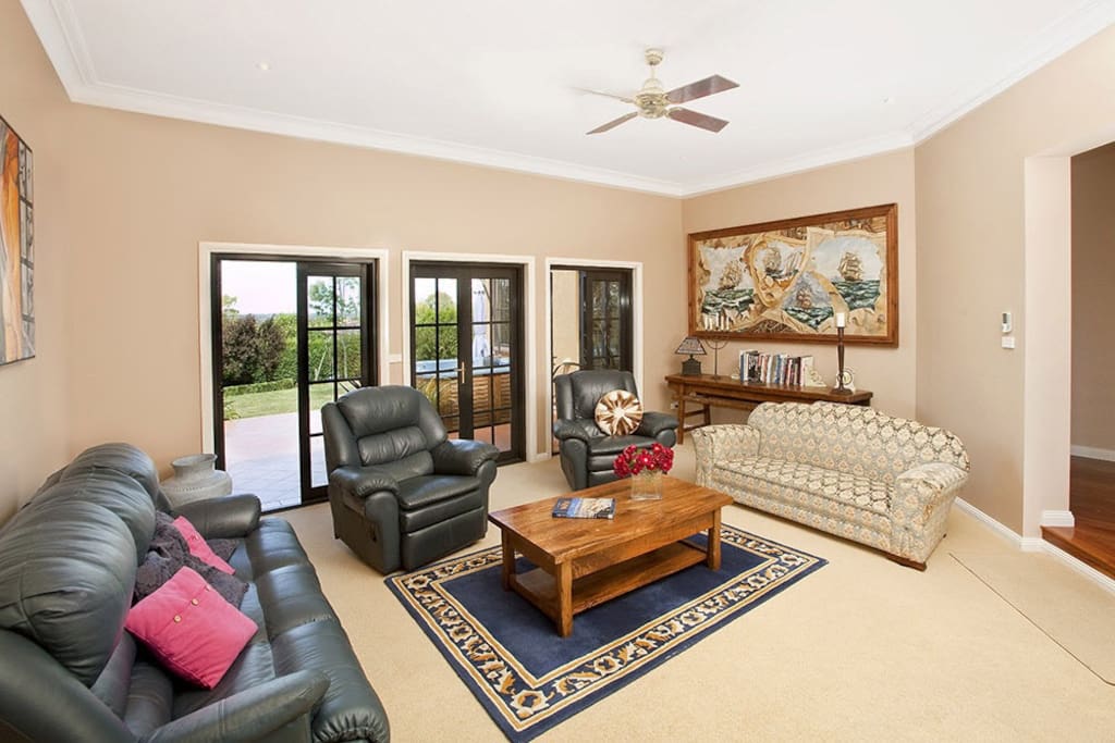Living room, which opens out to rear entertaining area.