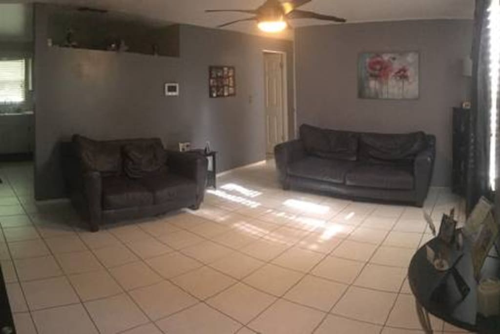 Shared living room with sofa, love seat, and TV.