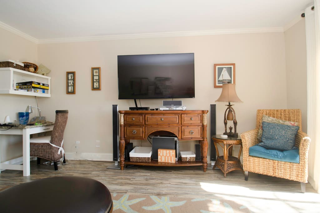 The living room has a large screen TV and a desk for your laptop.