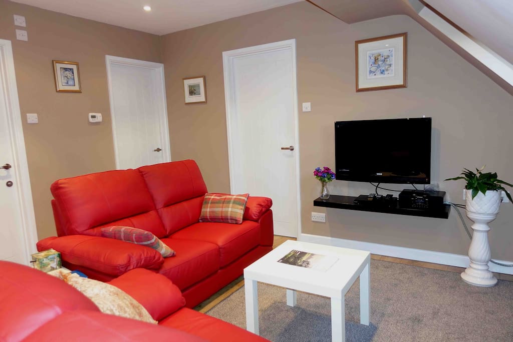 Lounge area with entertainment electronics: TV, DAB radio and DVD player
