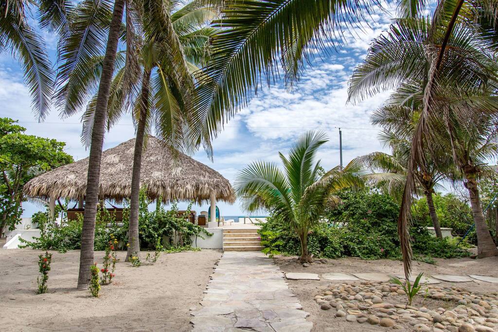 This is the same side of previous photo - for a farther distance and different time of year before flowers bloom. This view is arriving to the beach front pool area. It has a shallow and deep end; has build in table.