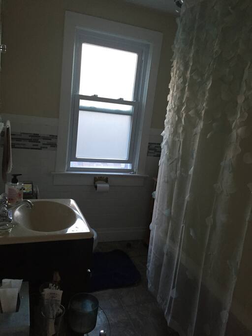 Well sized bathroom with claw foot tub & shower.