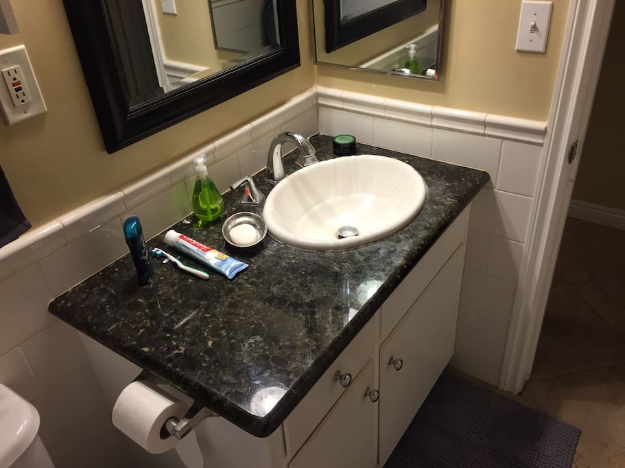 Small bathroom w/ a hot shower and fresh towels.