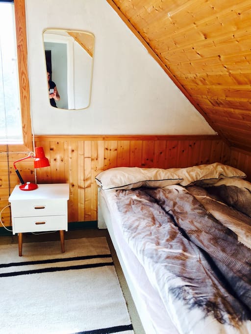 The bed with a lamp. Behind there's wall sockets to charge phones and cameras