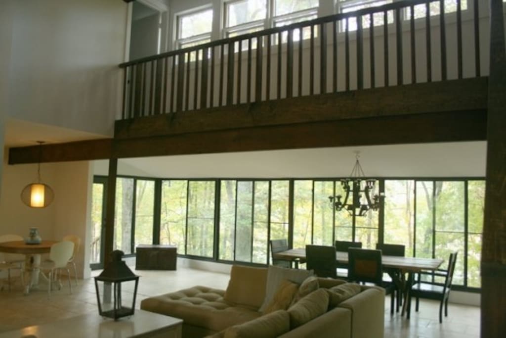 Living room overlooking water with screened windows that open up