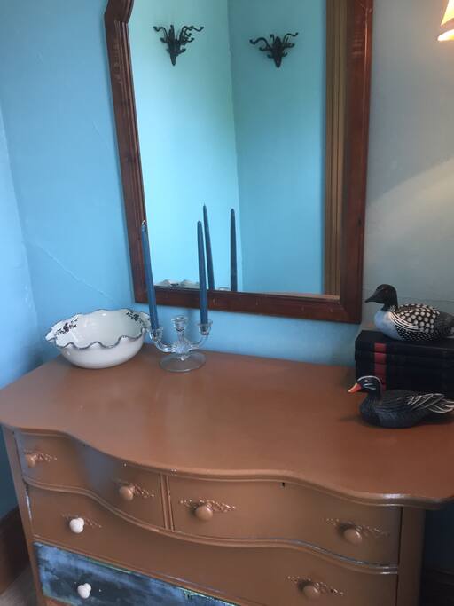 A little alcove of the room has drawers and hanging space for towels and clothes.