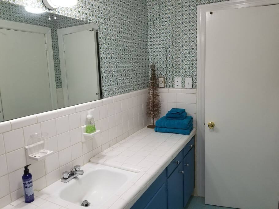 Bright and clean bathroom with full size tub shower.