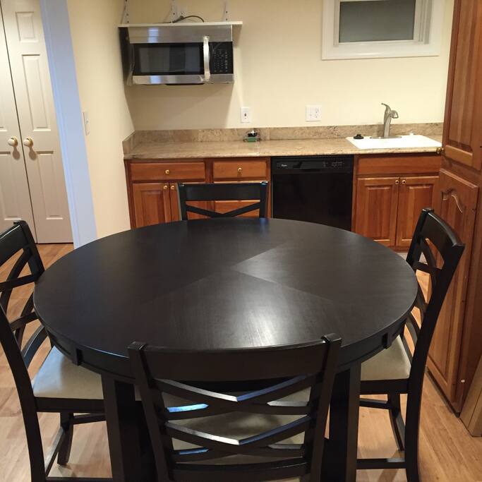 Eat-in kitchen with granite counters and cherry cabinets.