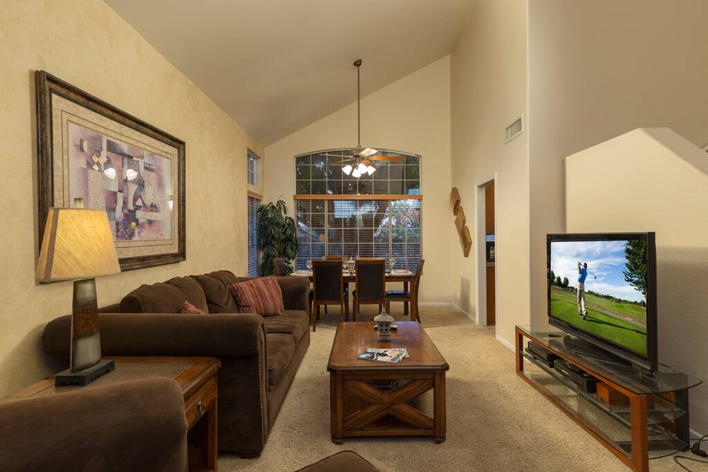 Living room with plasma screen TV and amazing huge windows with great views.