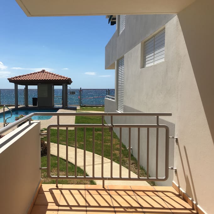 Balcony view of pool and sea