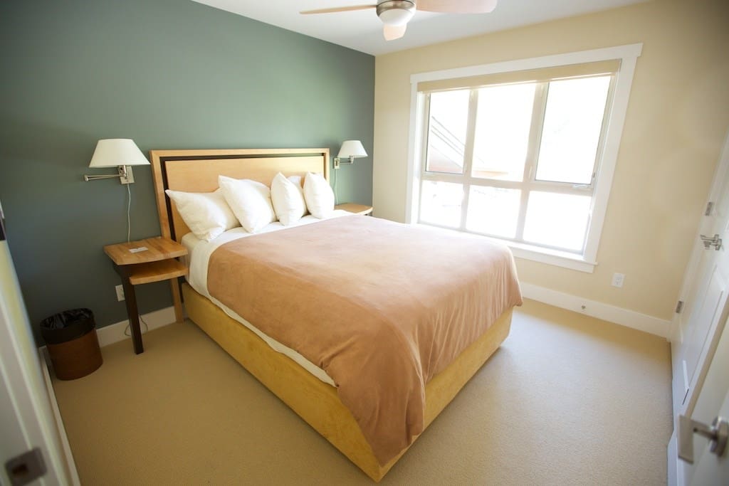 The second bedroom includes a plush queen bed