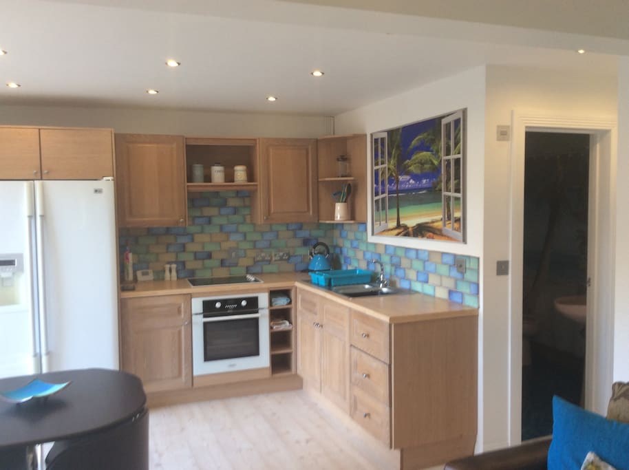 Kitchen/dining area with American fridge-freezer.