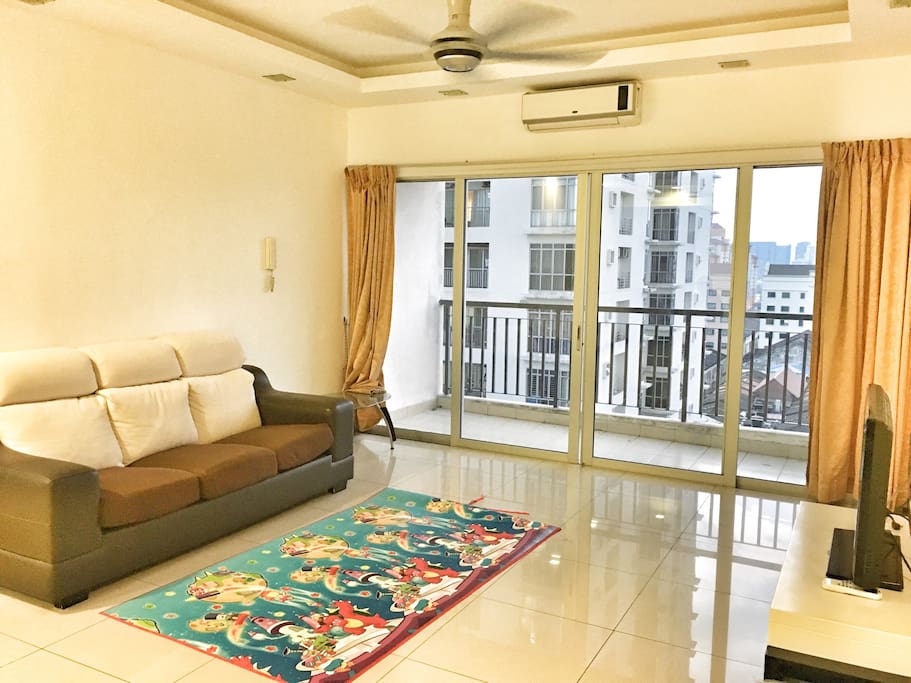 Living room with sofa, TV, air condition, ceiling fan & balcony