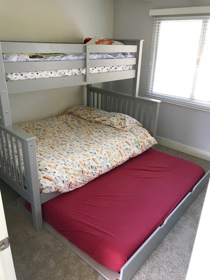 El dormitorio para niños tiene una litera con cama nido extraíble.  La litera superior es un colchón individual (también conocido como doble), la litera inferior es un colchón de espuma viscoelástica de tamaño completo y una cama nido con un colchón de espuma viscoelástica.  El armario está lleno de juguetes y un contenedor de lego.