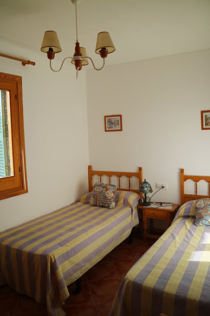 Jedna od spavaćih soba na katu  s dva kreveta za jednu osobu. // Jedna od soba na katu s dva odvojena kreveta.