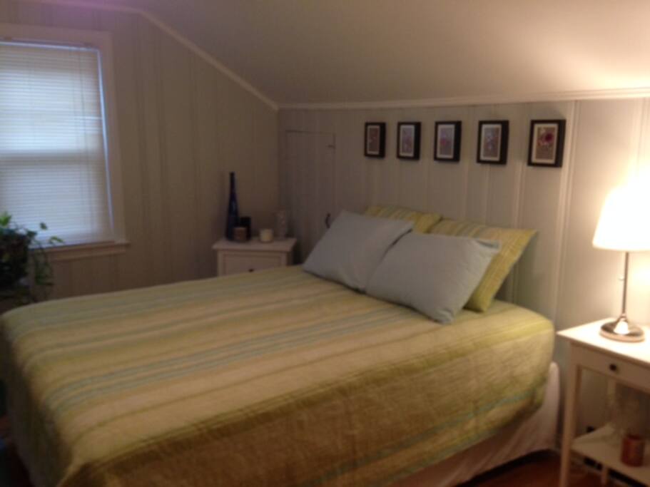 Another view of the queen size bed, two night stands.