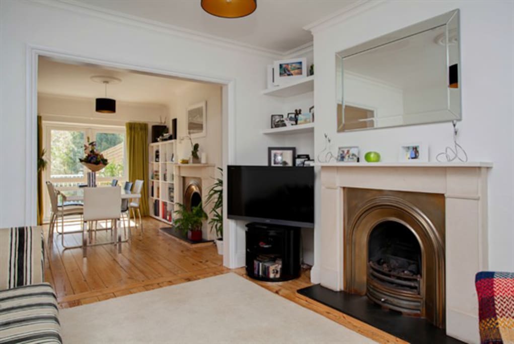 Lounge/diner/playroom with gas fire and digital TV, doors open to garden