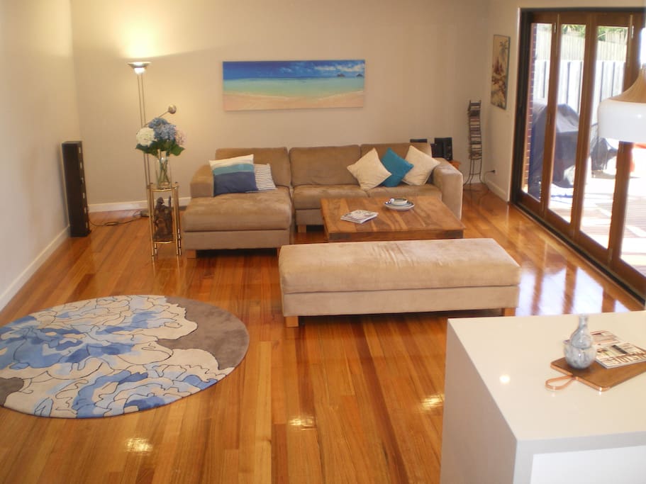 Relax in the spacious lounge. Doors open fully onto the deck.