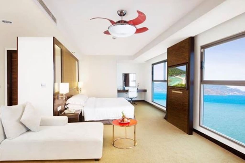 King-sized bed, very big window with ocean view
