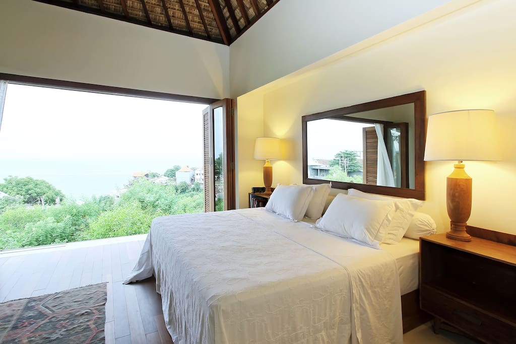 master bedroom with view to ocean and the waves in uluwatu.