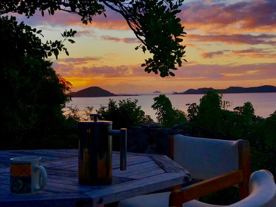 Coffee with rising sun over the sea and islands