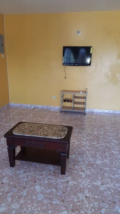 living room with flat screen tv and cable