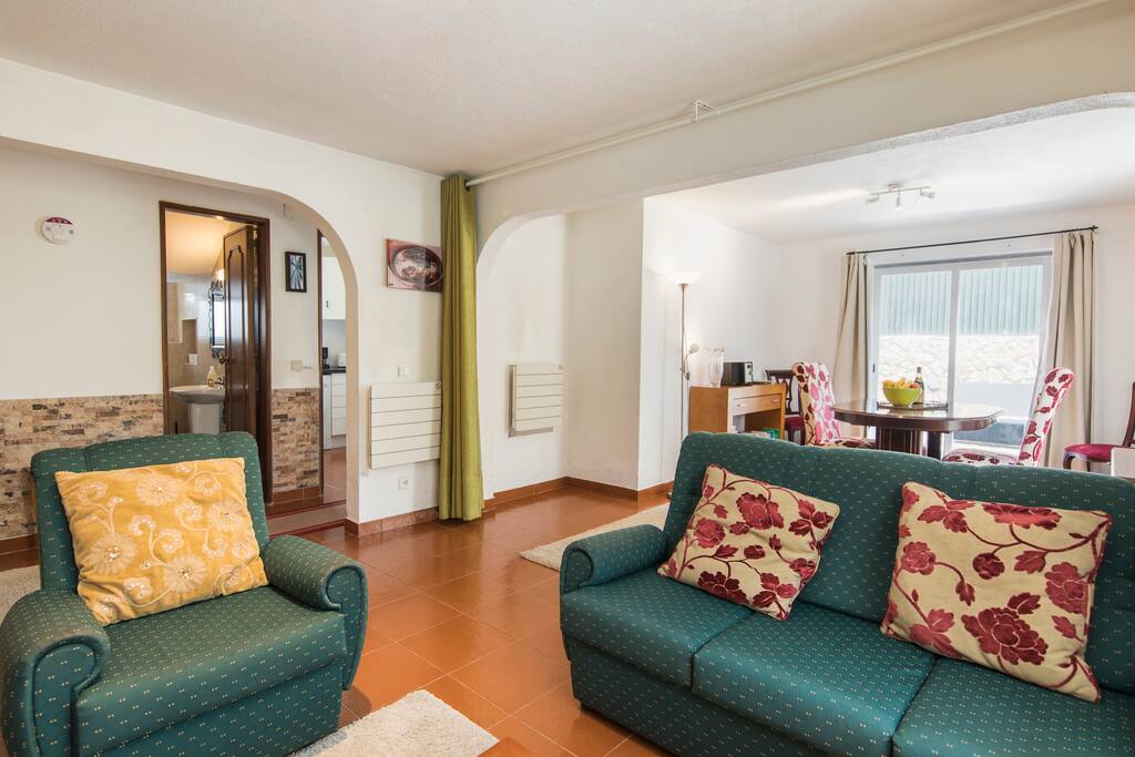 Living room with seating area, dining area leading onto outside decking