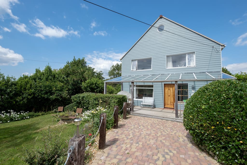 Large south facing veranda, drive way for 3 cars and half an acre of mature garden.