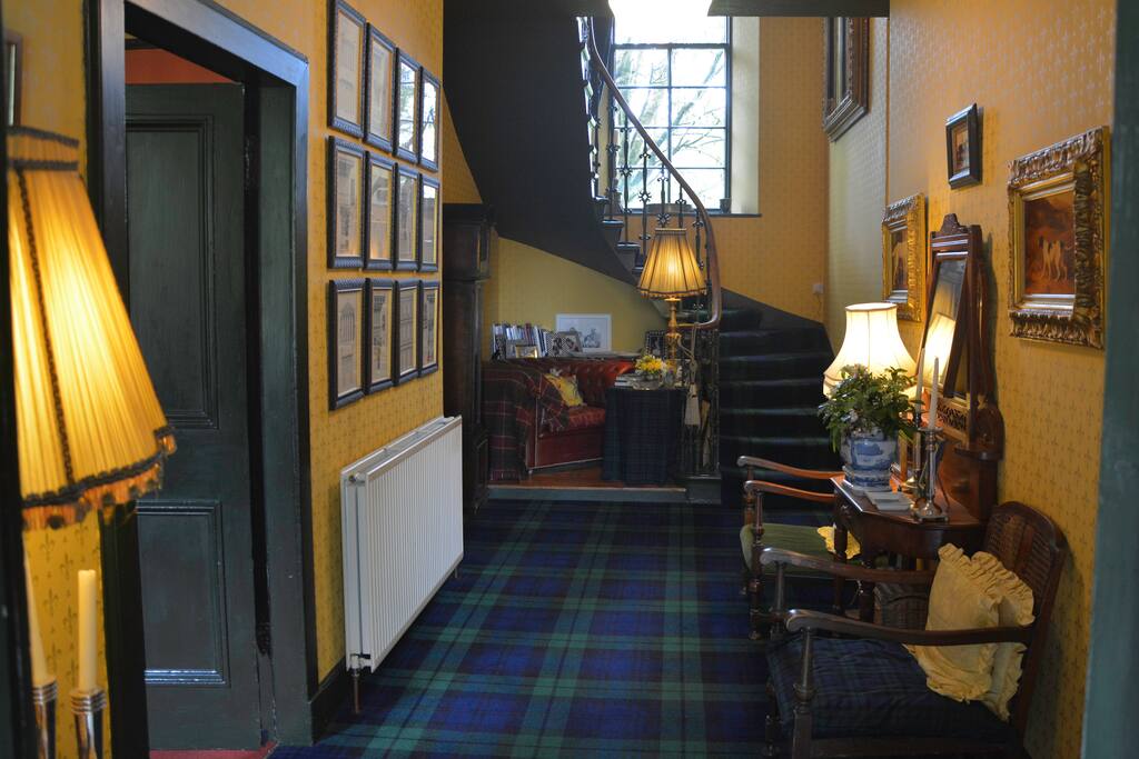 Large traditional Entrance Hall with Black Watch tartan carpet.