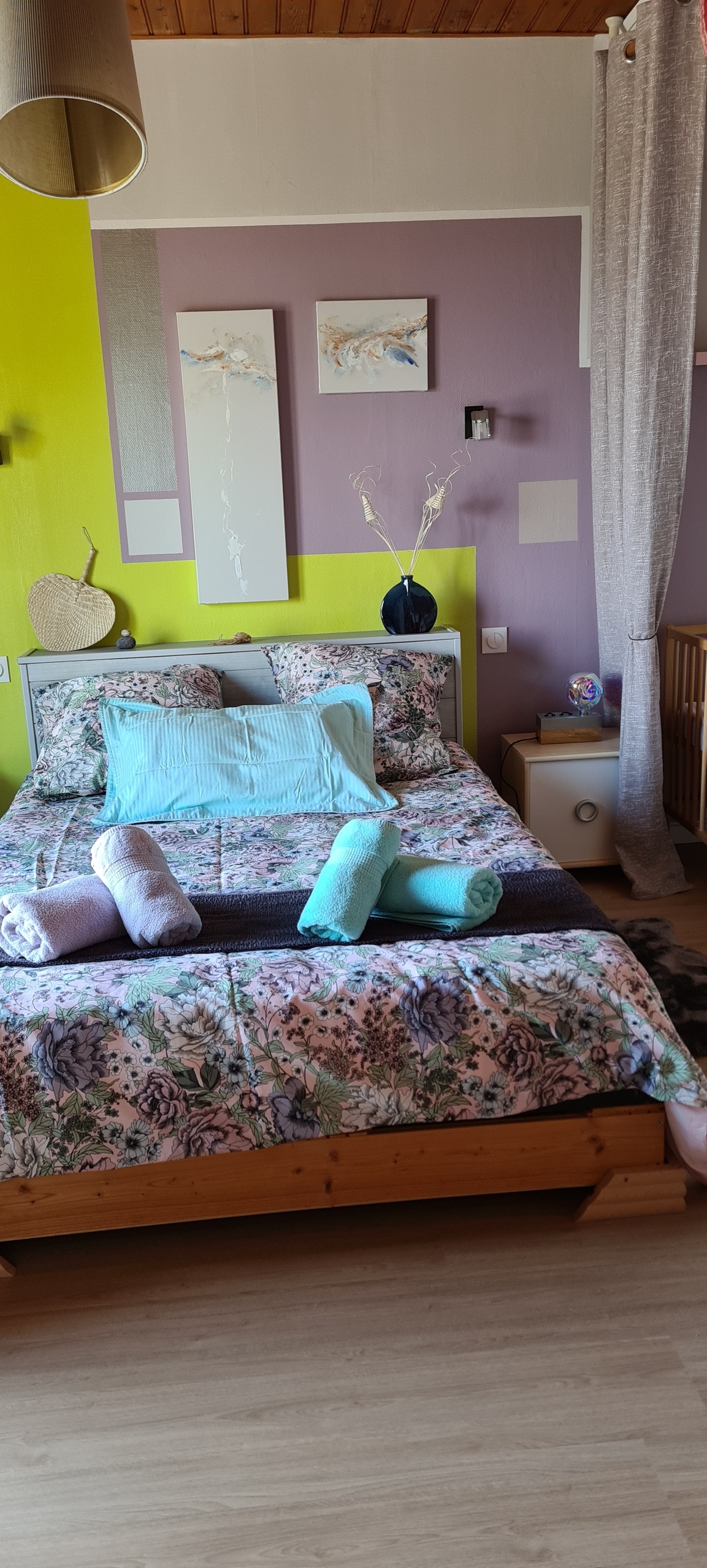 A l'étage, la chambre n°3 avec un lit double, un lit bébé à disposition et un accès direct à la terrasse par la porte fenêtre