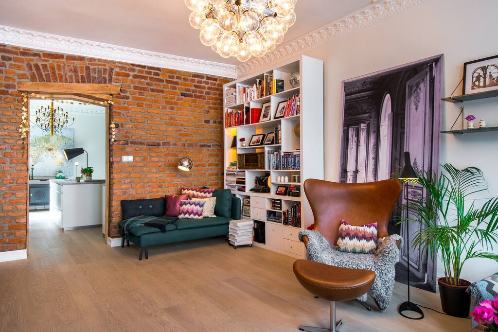 Our lovely green chillout couch is the perfect place to relax after a long day. Notice the little white-painted coffee table created by Anne Merete, made up by old encyclopedia books on wheels.