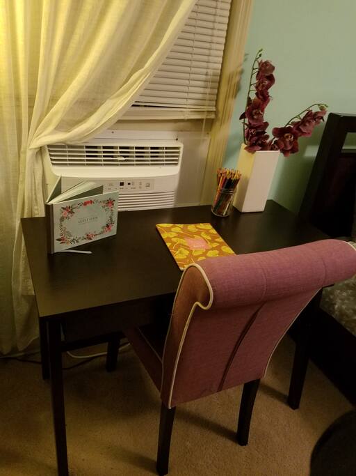Desk and window AC unit. Suite has centralized heat/air as well.